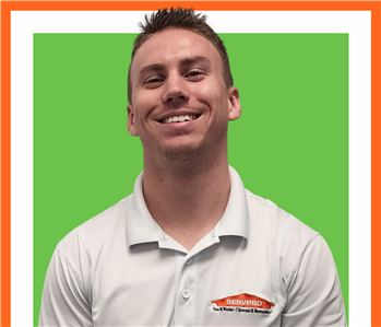Justin, SERVPRO male in uniform against a green background